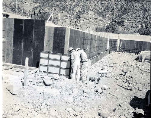 Placing steel and forms for concrete basement walls at Mission 66 Visitor Center and Museum construction.