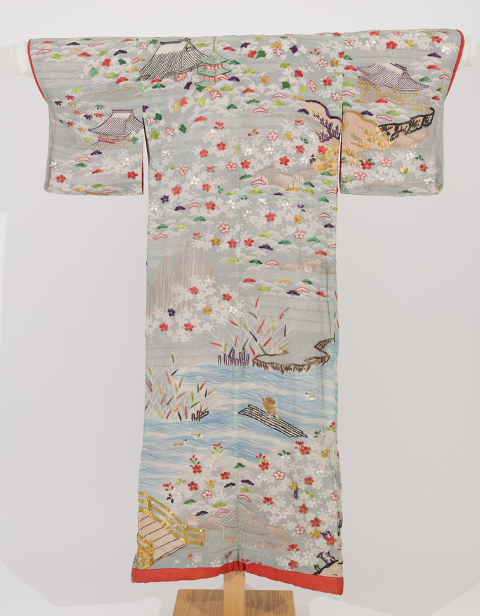 Full length, embroidered, white silk crepe outer kimono decorated with a landscape scene.  Gold, purple, orange, white, green and brown.  Padded hem.  Orange silk lining.