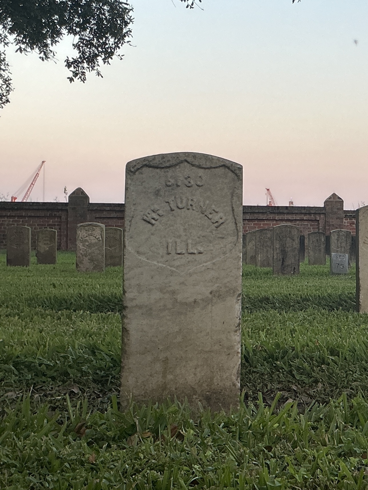 Front of historic upright marble headstone with recessed shield face.