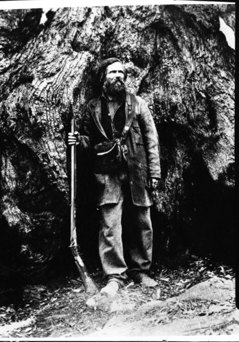 Galen Clark as a young man standing beside Grizzly Giant in Mariposa Grove. Copied from stereo from LA museum. Dated early 1860's, but likely 1858-1859.