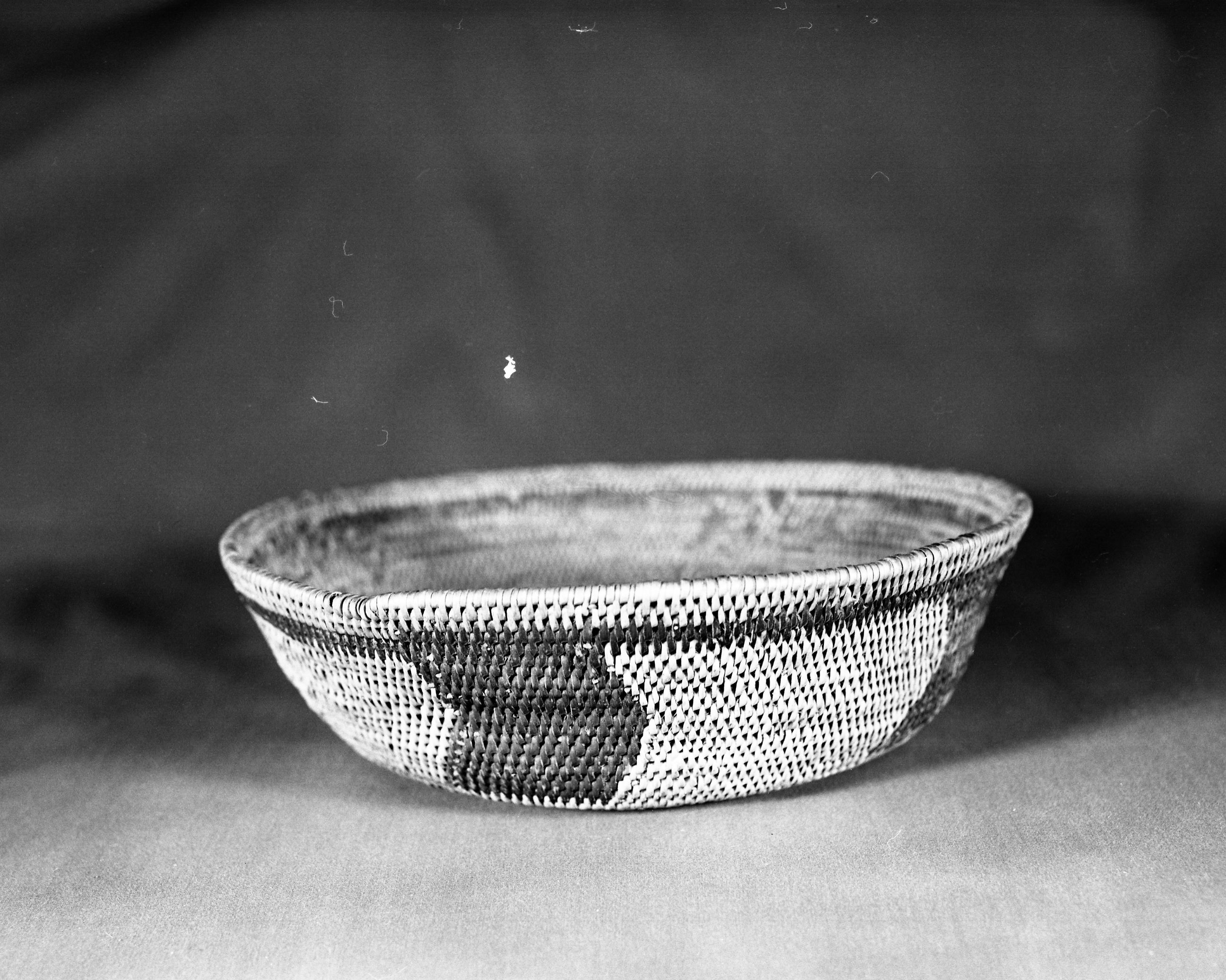 Private Collection. Object: Miwok basket. Dimensions: 10 1/2 x 3". Materials: Redbud (probably spring redbud). Technology: Single rod, interlocking stitch, fag ends trimmed on work face, moving ends trimmed on interior, clockspring heavily overstitched. Collection History: From near Jamestown. Photographed by Michael Dixon. Catalogued by Craig Bates and Barbara Beroza. Yosemite Collections, National Park Service.