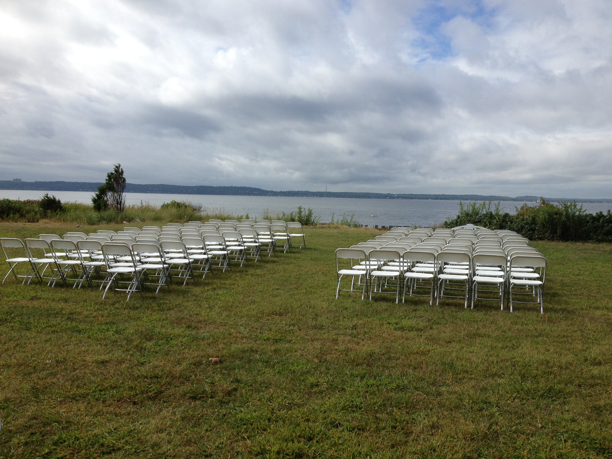 Rows of chairs facing body of water