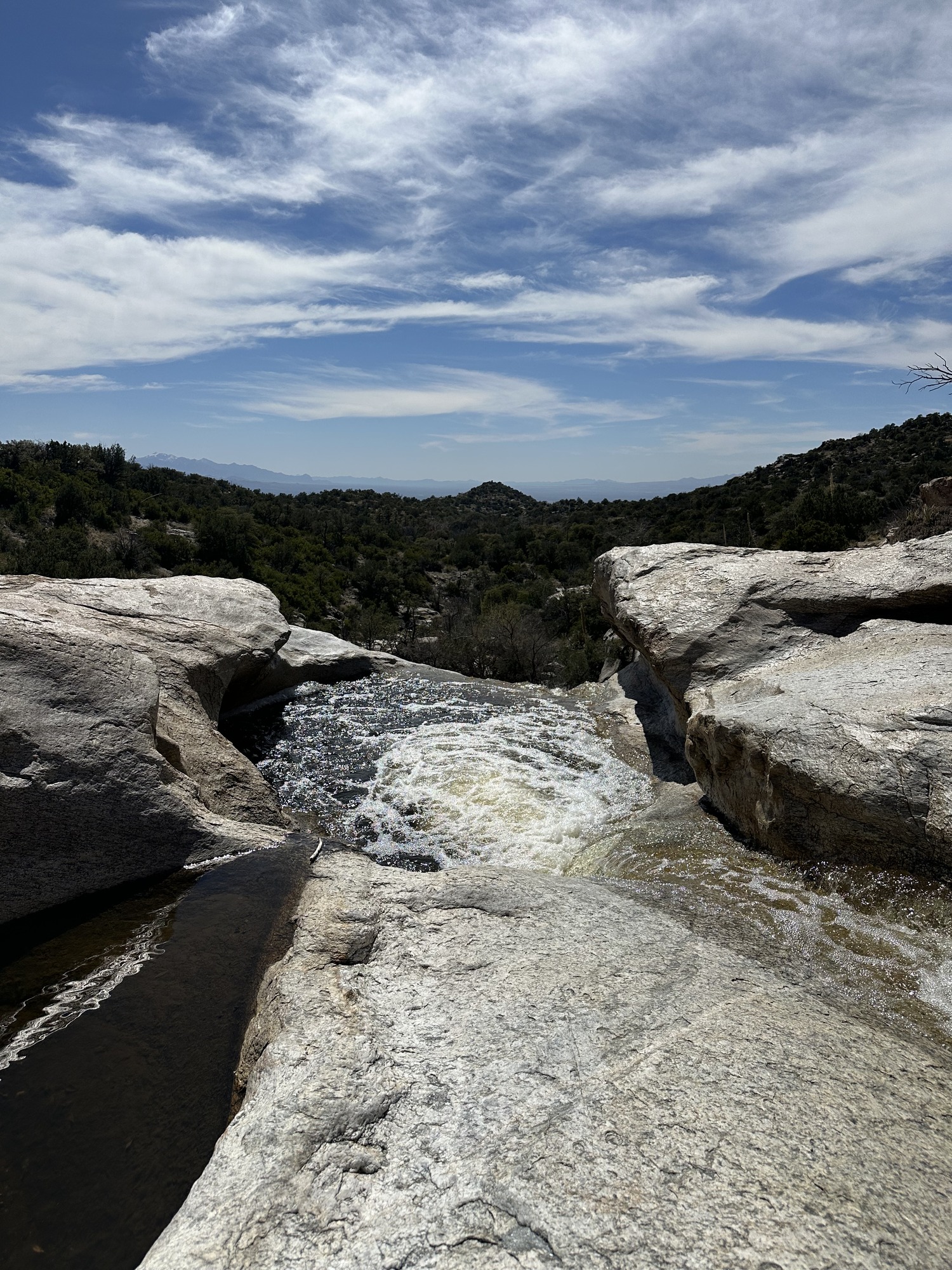 water flows down a rocky drainage 
