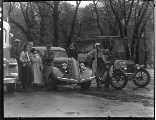 Prize winner Graham, visitors, and old Ford. Gilmore Economy Run. [See also: History; Individuals; Gilmore, Ray #2375].