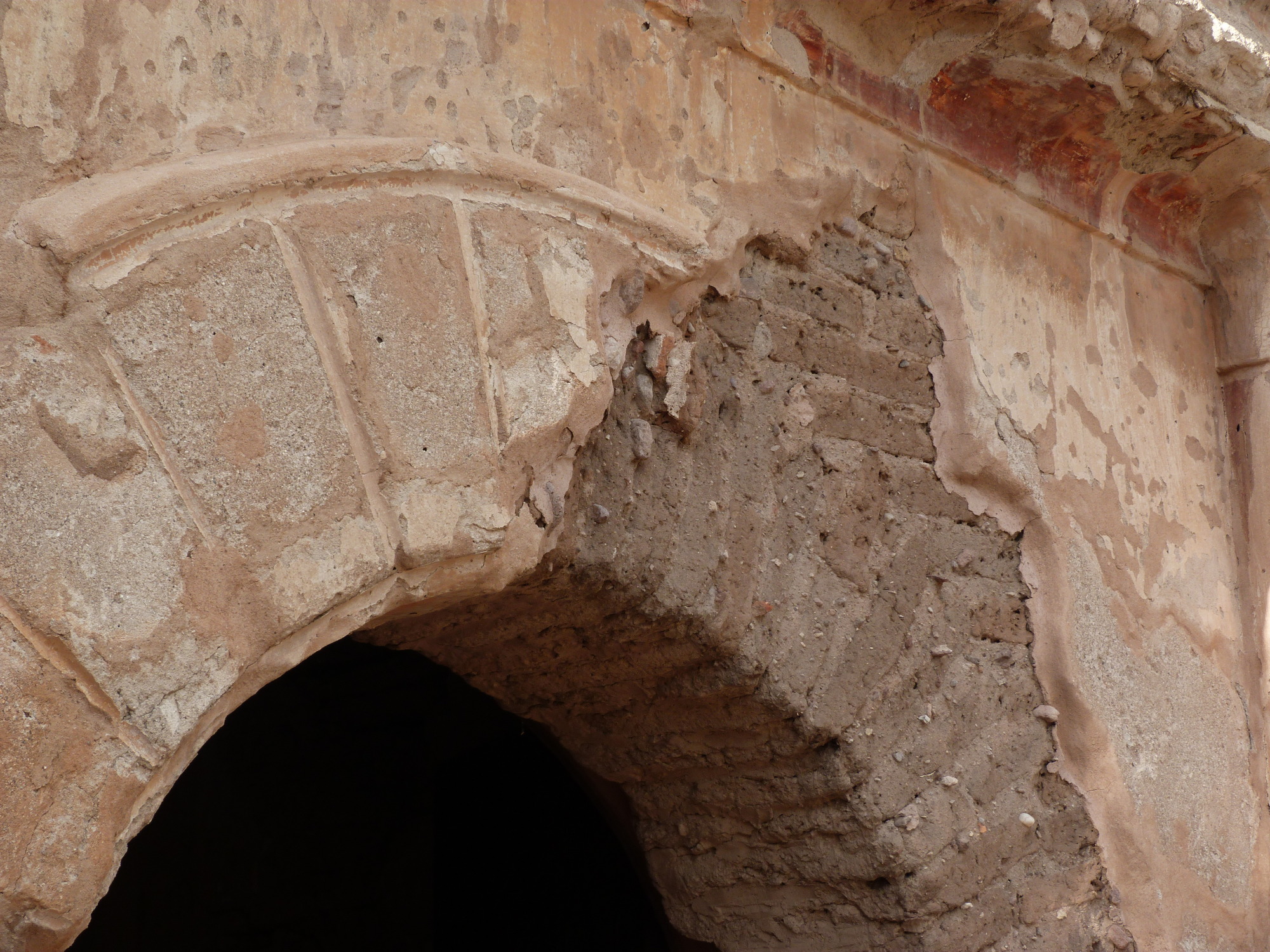 Detail of re-constructed arched doorway with exposed adobe bricks