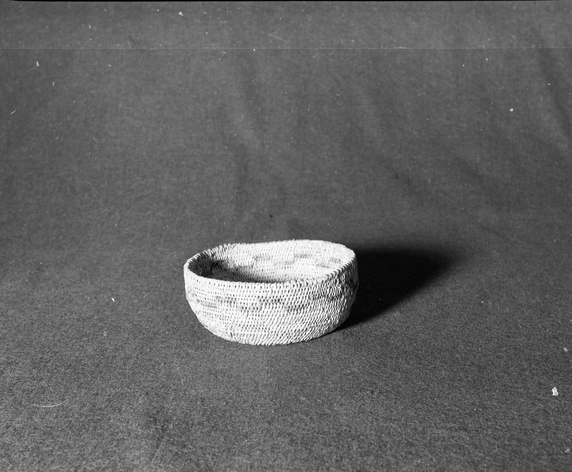 Marie Rozier Collection, Catalog No. 75. Object: Miwok basket. Dimensions: 6 x 2 1/2". Materials: Bull pine and fern root. Technology: Single rod, fag ends trimmed on work face, moving ends clipped on interior or bound under. Collection History: Made for Mrs. Ida Hallen about 1915 by a local Native American woman. Gift of Florence Whitcomb. Photographed by Michael Dixon in December 1982. Catalogued by Craig Bates and Barbara Beroza. Yosemite Collections, National Park Service.