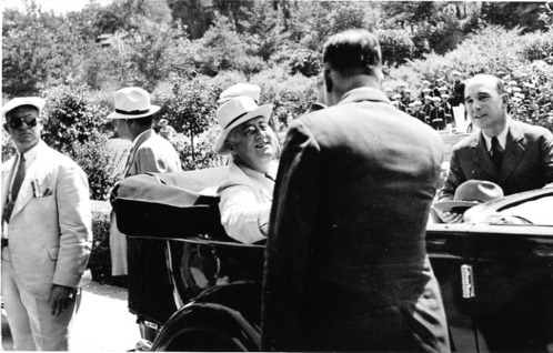  President Franklin Delano Roosevelt in Hot Springs during a campaign trip. Roosevelt is in the back seat, Supt. Thomas Allen is standing by the driver's door, and Supt. Donald S. Libbey has his back to the camera, talking to President Roosevelt.