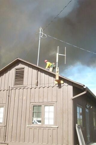 Firefighters battle flames in structures during the Long Mesa Fire, Mesa Verde National Park, July-August 2002