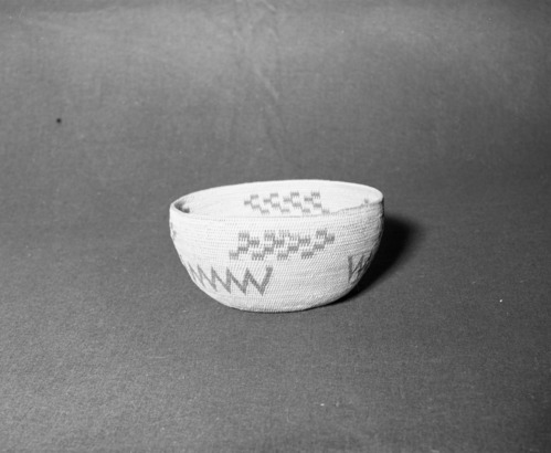 Mrs. Donald Segerstrom Collection. Object: Miwok basket. Dimensions: 8 1/4 x 4". Materials: Bracken fern root, split shoot. Technology: Single rod foundation, slanting overstitched rim, design in three groups in tow rows. Photographed by Michael Dixon. Catalogued by Craig Bates and Barbara Beroza. Yosemite Collections, National Park Service. 1/83.