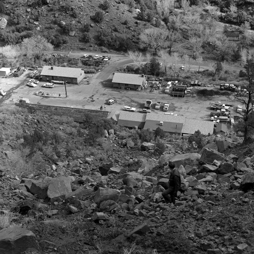The March 9, 1978 rock fall which damaged plumber shop, R.D. Pollock visible on the hill overlooking the Oak Creek maintenance yard.