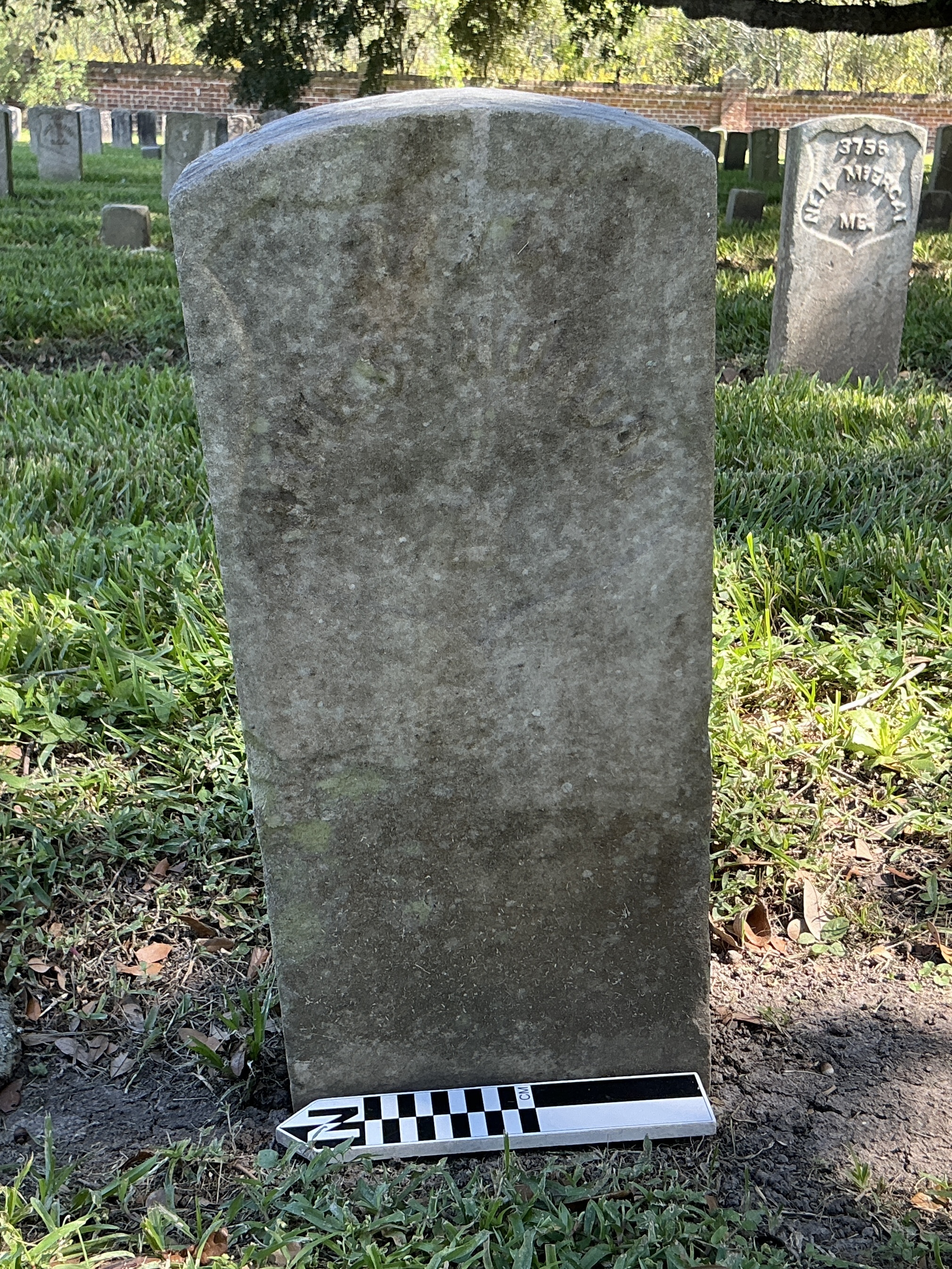 Extra image of historic upright marble headstone with recessed shield face.
