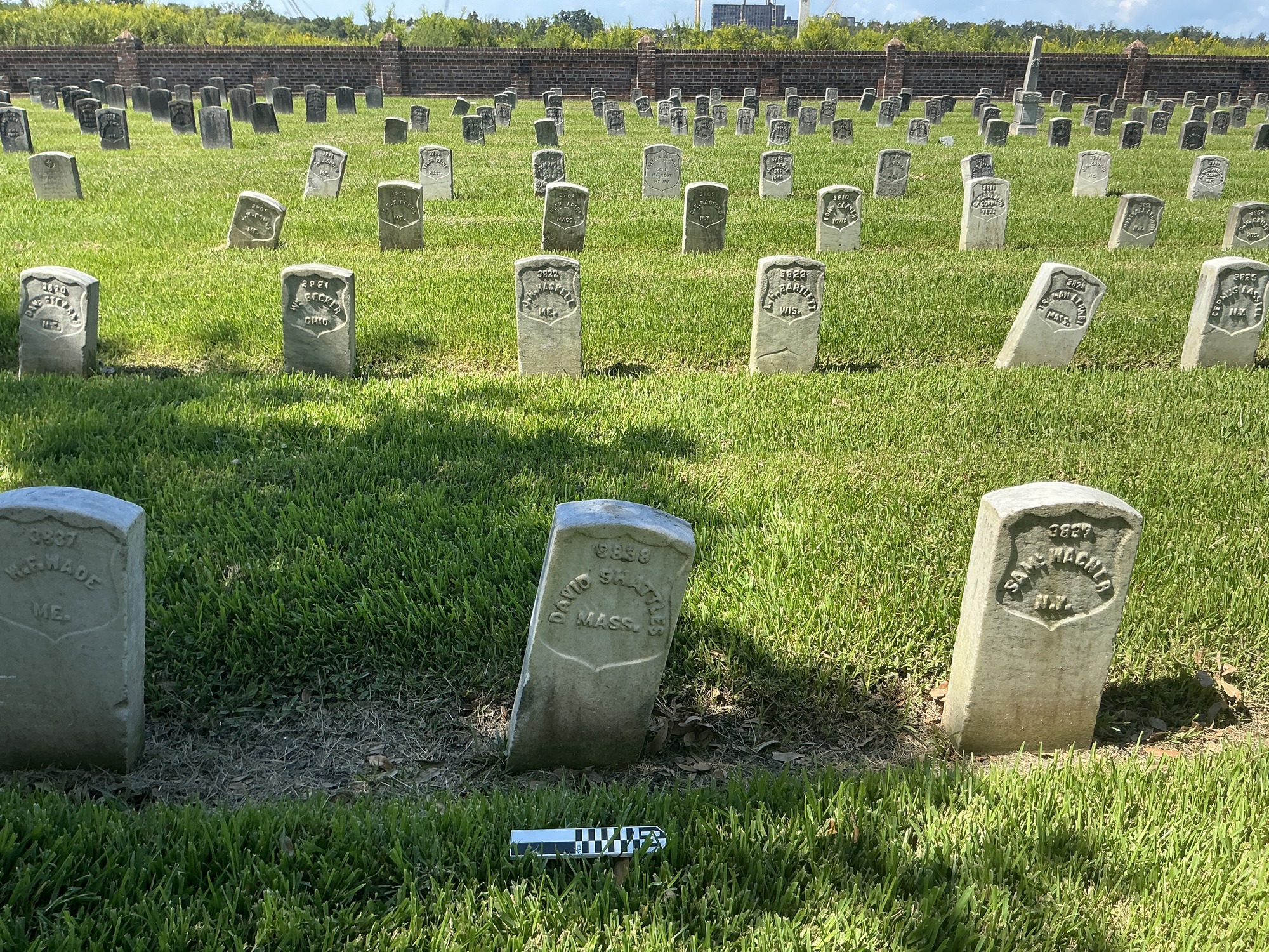 Extra image of historic upright marble headstone with recessed shield face.