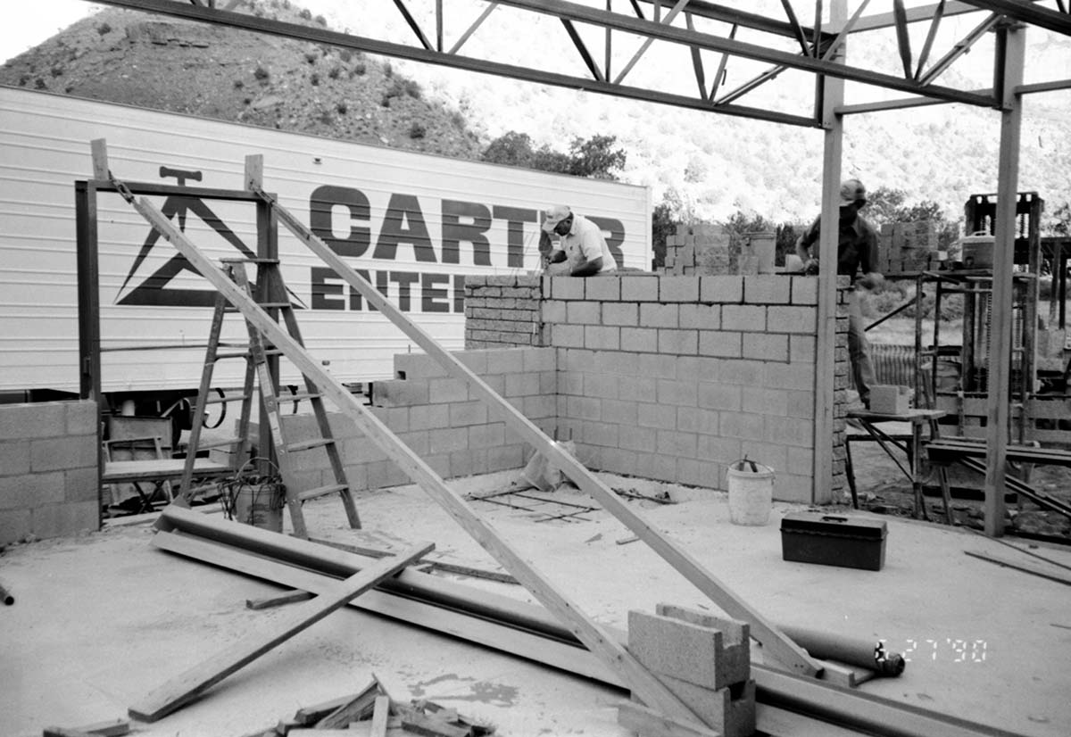 Workers building brick wall during the construction of the headquarters addition.
