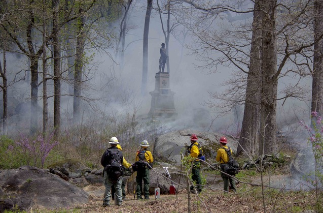 Wildland firefighters closely monitor the Little Round Top prescribed fire as it slowly moves around the 83rd Pennsylvania infantry monument.
