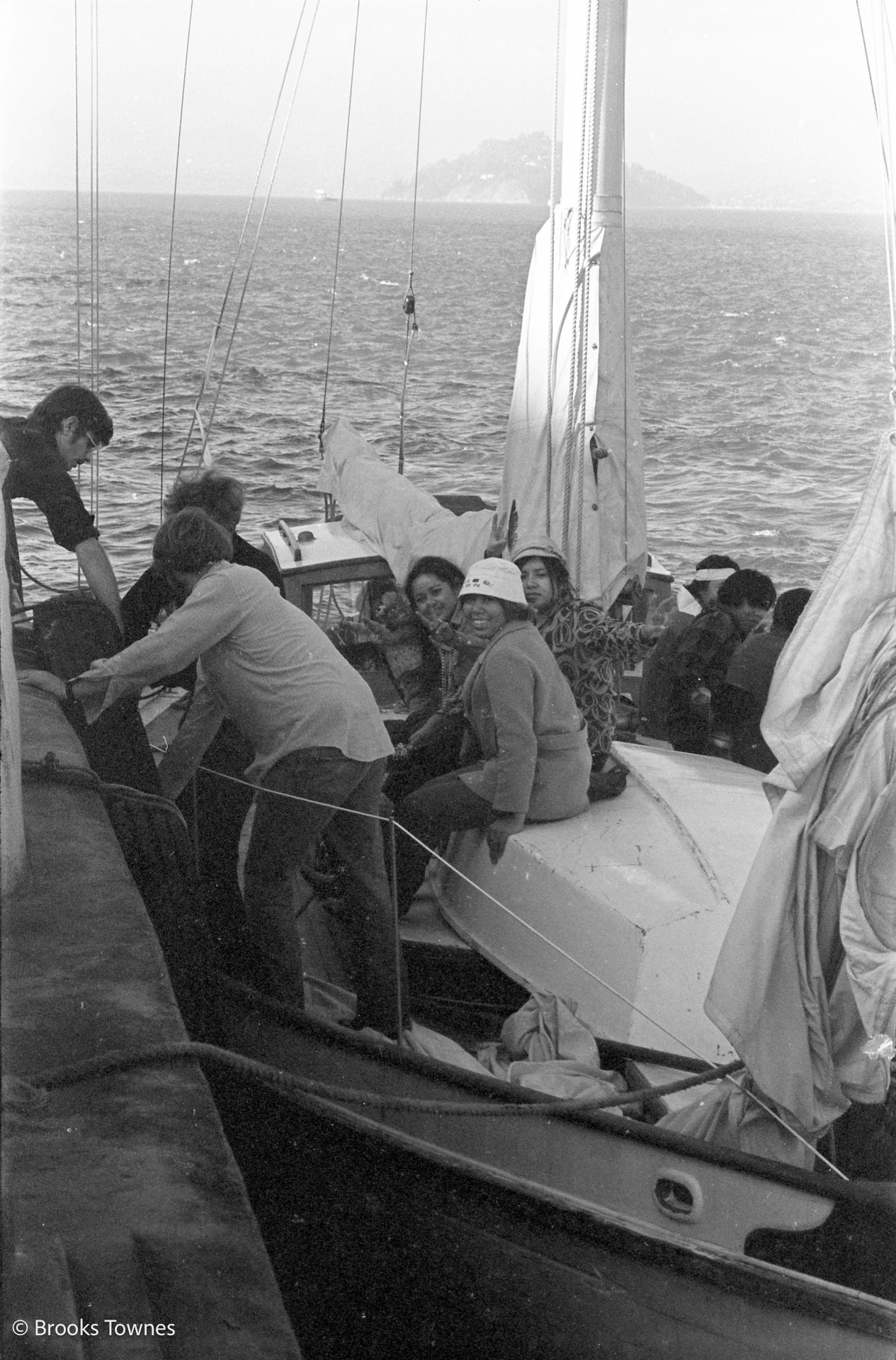 Occupiers sit on a sailboat as it is readied to sail to Alcatraz visible in the distance
