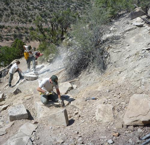 ARRA funded trail workers shaping rocks for retaining walls, steps, and checks at Colorado National Monument in Summer 2009.