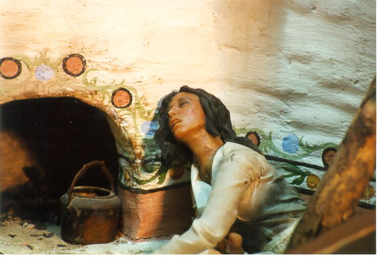 Closeup of woman lying on the ground in diorama of rebellion scene, pained expression