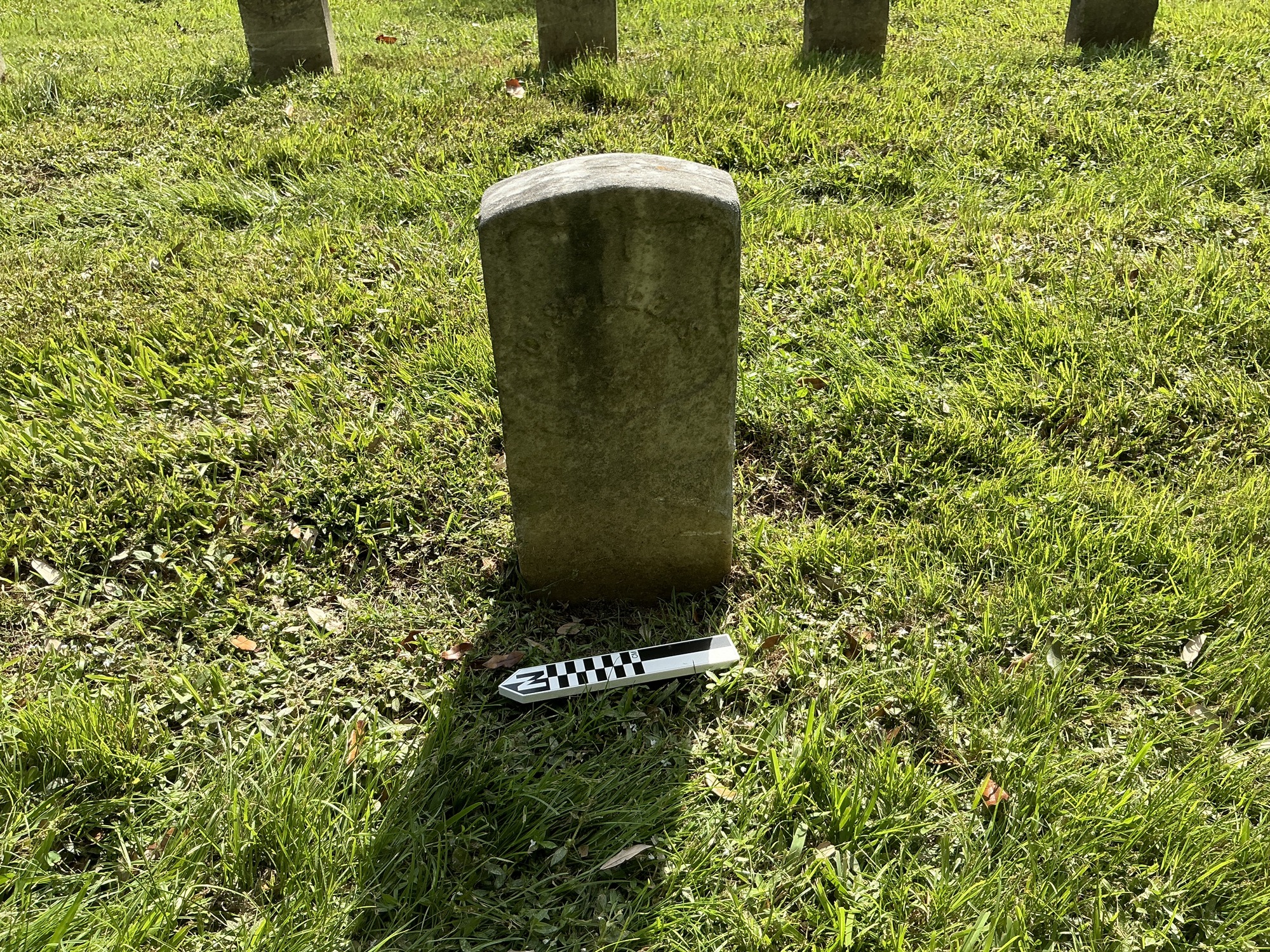 Extra image of historic upright marble headstone with recessed shield with recessed lettering face.