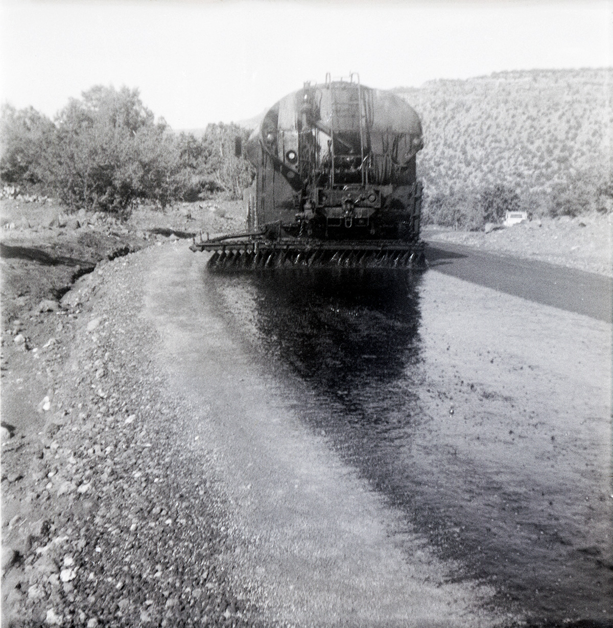 View from behind of construction vehicle during chipsealing of Kolob Canyon Road.