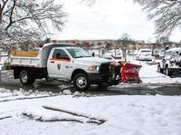 Truck plowing snow in a parking lot 