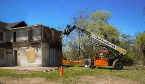Preservation crews begin removal of the second story of the non contributing historic addition to the Wisler house.
