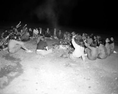 Group of girls in organized club enjoying a campfire circle in South Campground.