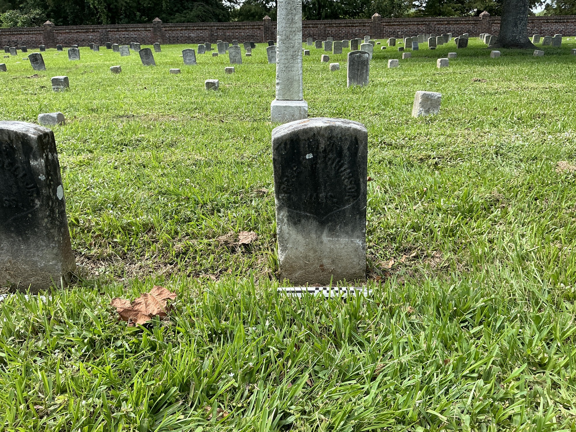 Extra image of historic upright marble headstone with incised shield face.