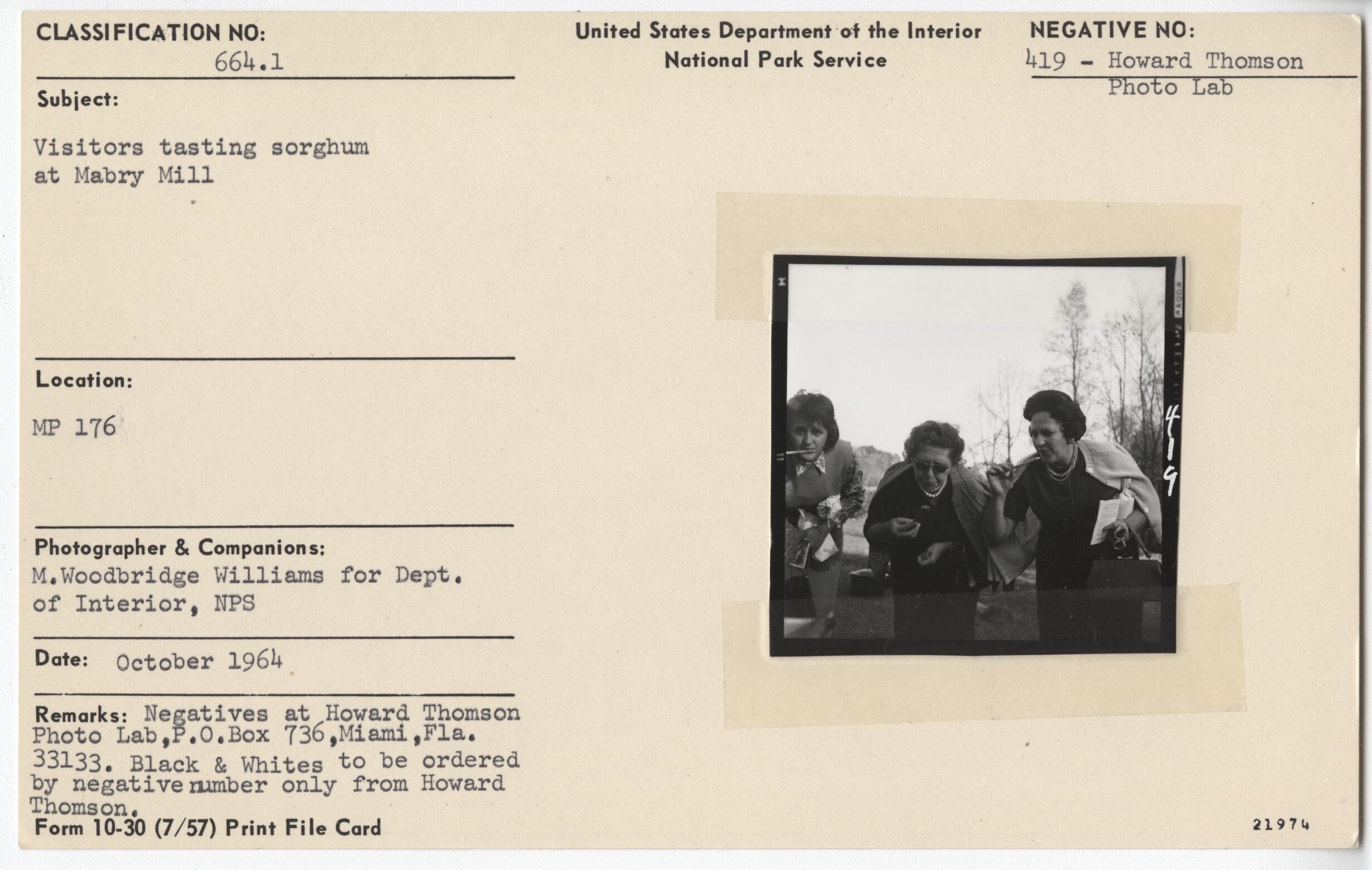 Visitors testing sorghum at Mabry Mill