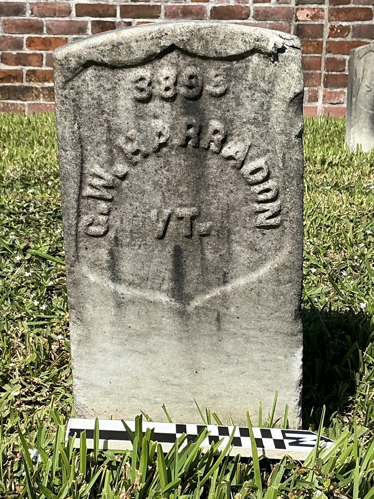 Extra image of historic upright marble headstone with recessed shield face.