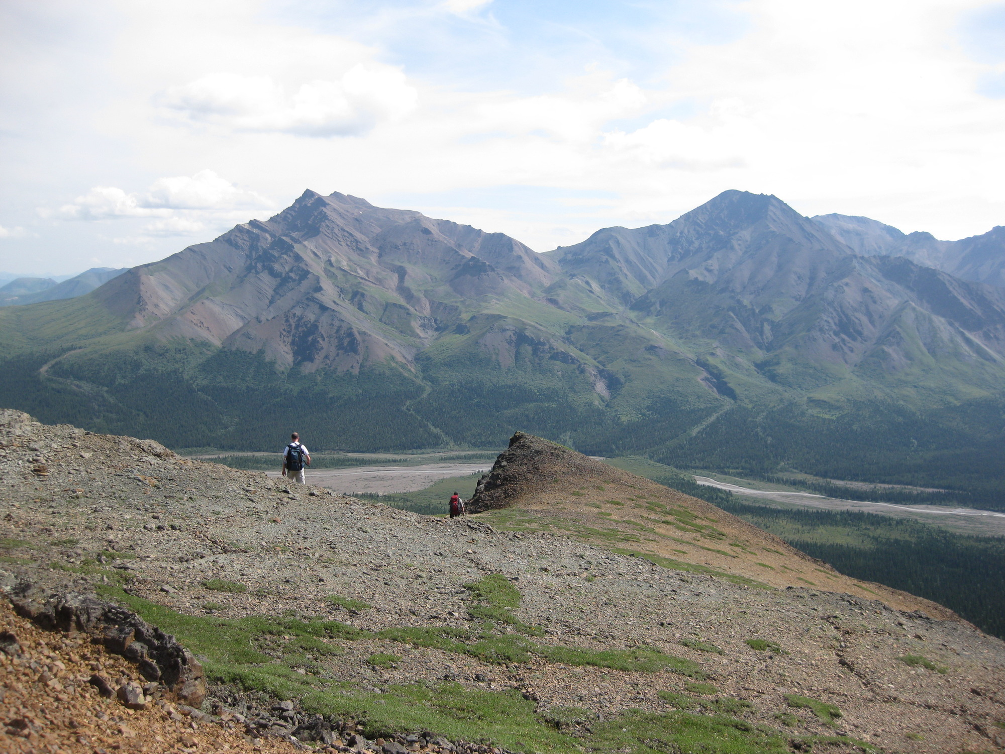 two people on a mountainside hiking