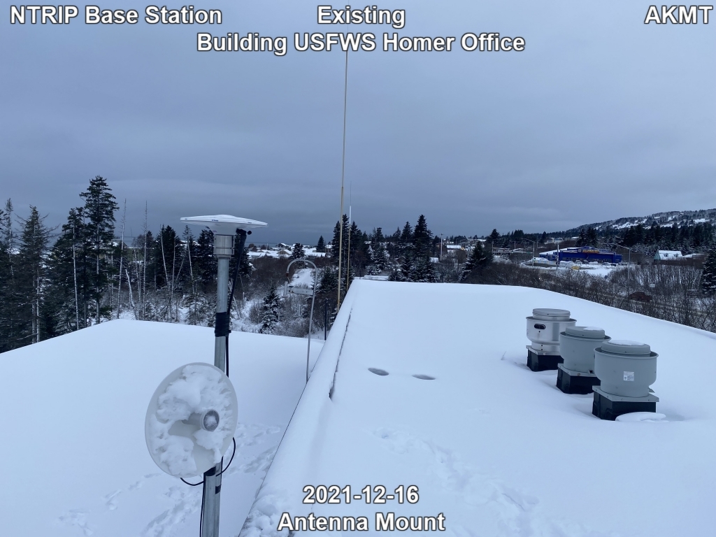 An antenna mount on a building rooftop