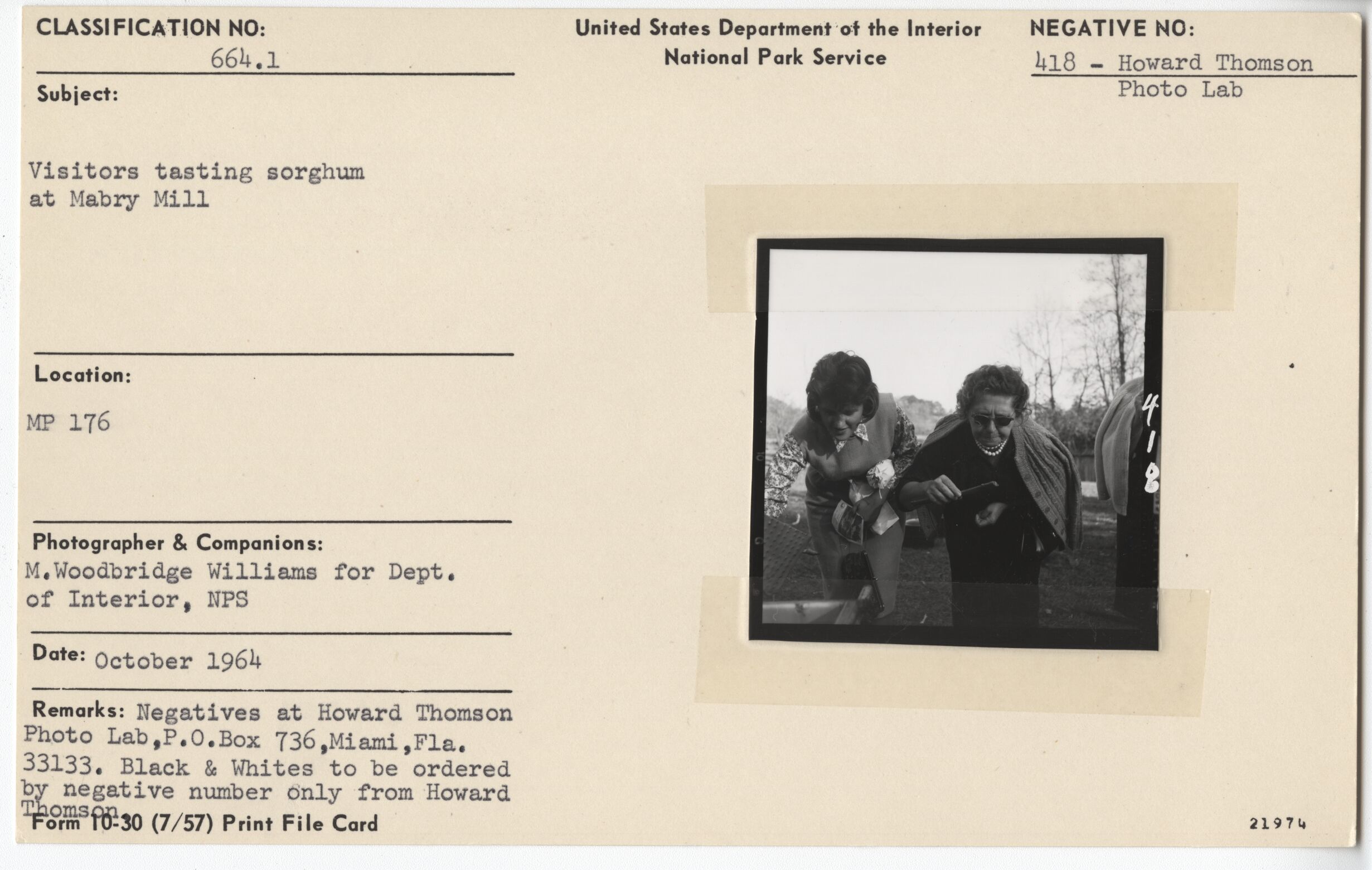 Visitors testing sorghum at Mabry Mill