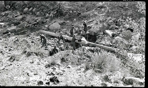 Pine Creek irrigation system with workers laying pipe.