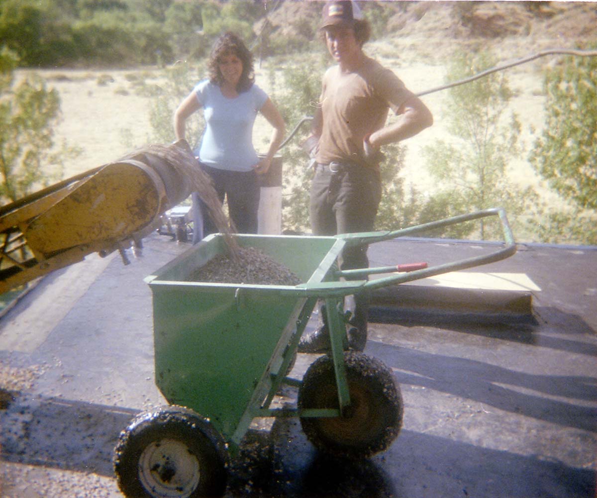 Workers standing by as a roofing cart is filled with roofing material during headquarters/visitor center roofing project.