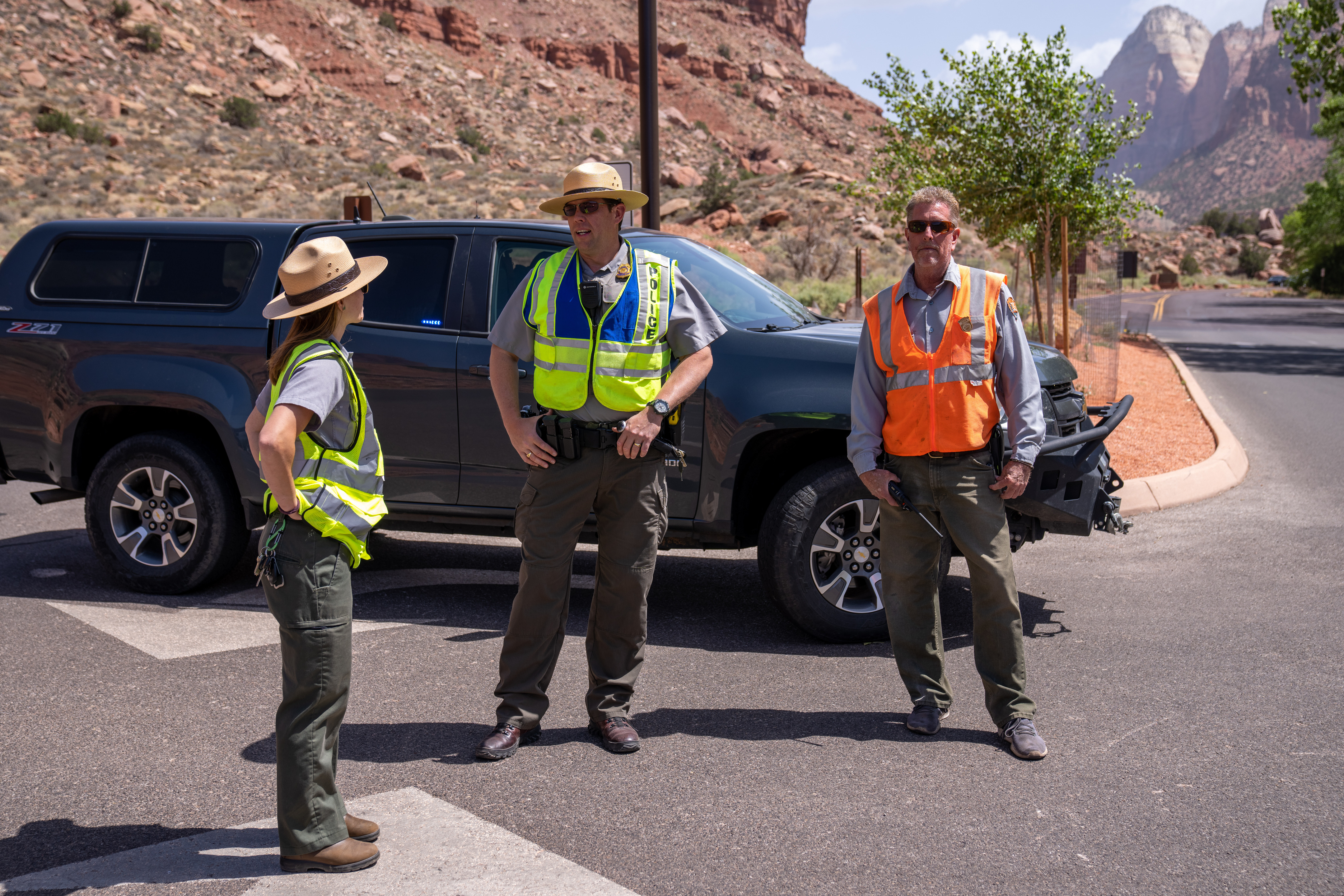 Three National Park Service Staff discuss operations near South Entrance of Zion National Park.