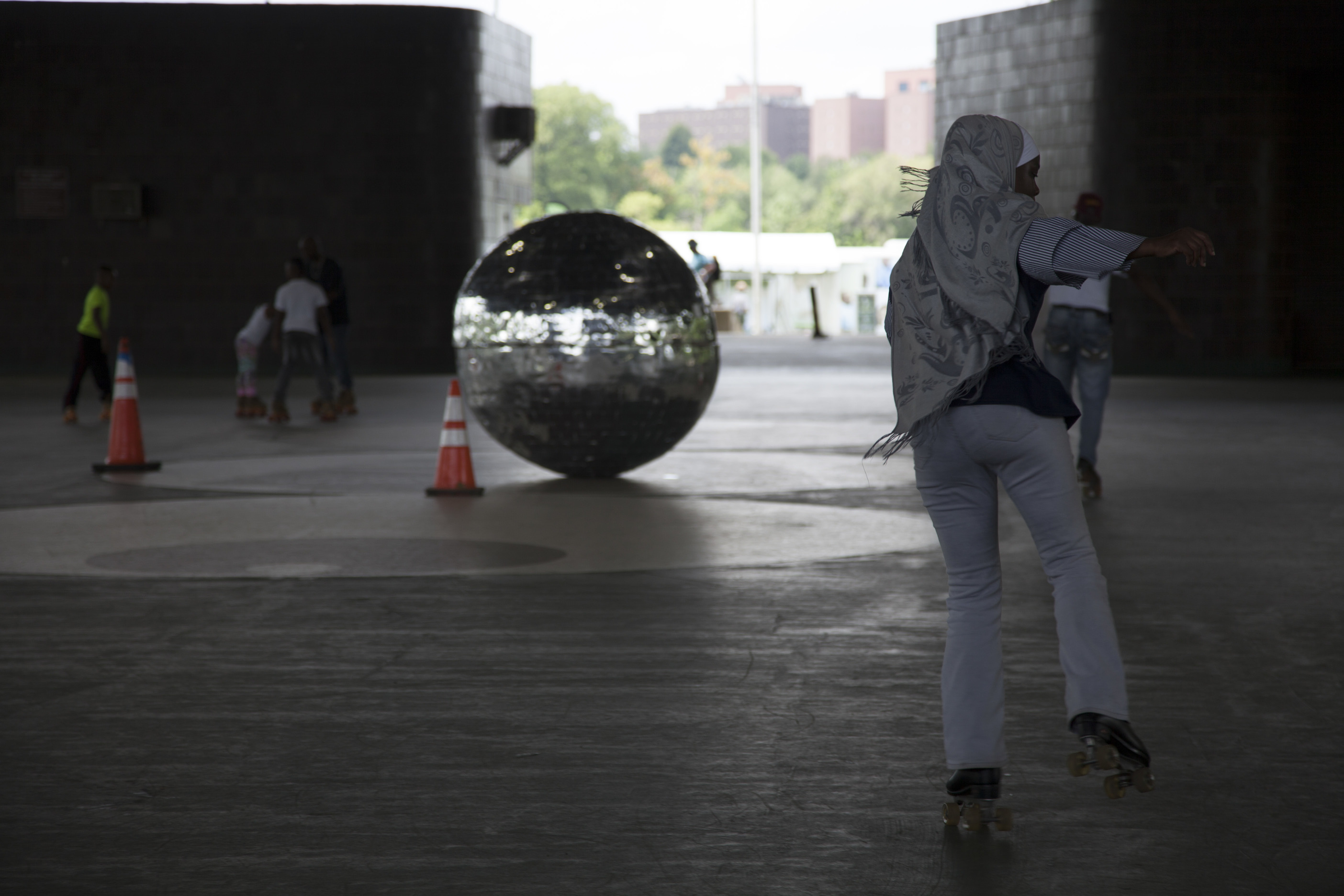A visitor skated past a large disco ball in the roller rink.