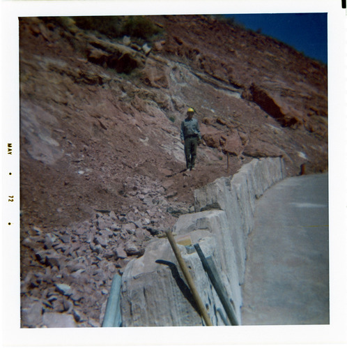 Man helping to construct the slide control wall along Kolob Canyon Road.