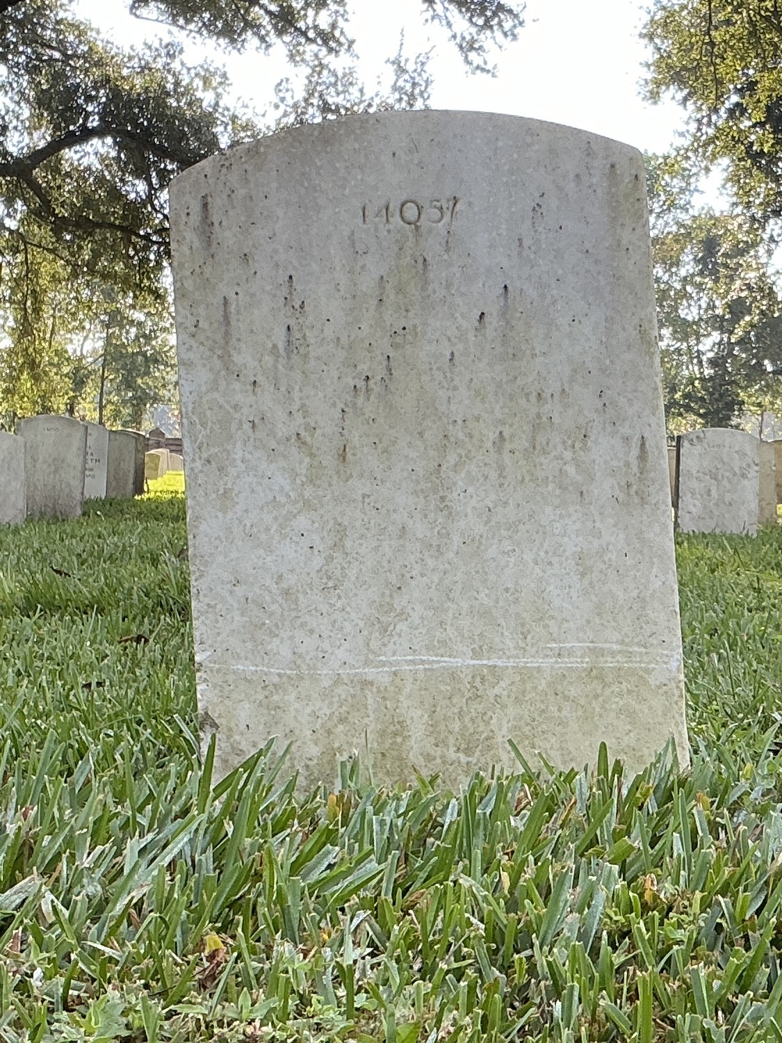 Back of upright marble headstone with flat face.