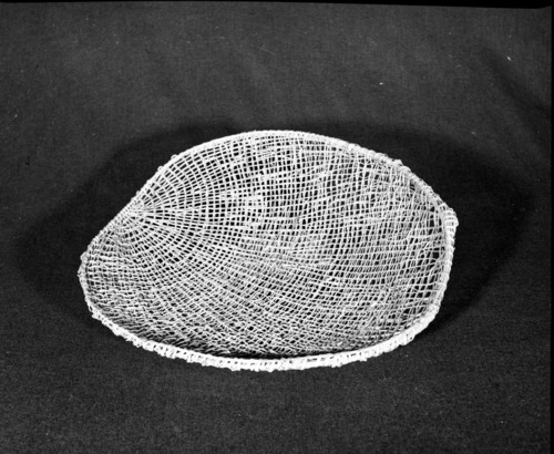 Marie Rozier Collection, Catalog No. 106. Object: Northeastern Maidu winnowing tray. Dimensions: 21" x 19". Materials: willow shoot, split maple. Technology: plain twined, whole peeled willow shoots used for twined elements, down to right slant of turns. Identical to those collected from Northeastern Maidu except workmanship coarser. Collection History: Formerly property of Carmelita Ralph, whose sister, Louise Fuentes, sold it to Marie Rozier. She said it was a tray for drying acorns. Photographed by Michael Dixon in December 1982. Catalogued by Craig Bates and Barbara Beroza. Yosemite Collections, National Park Service.