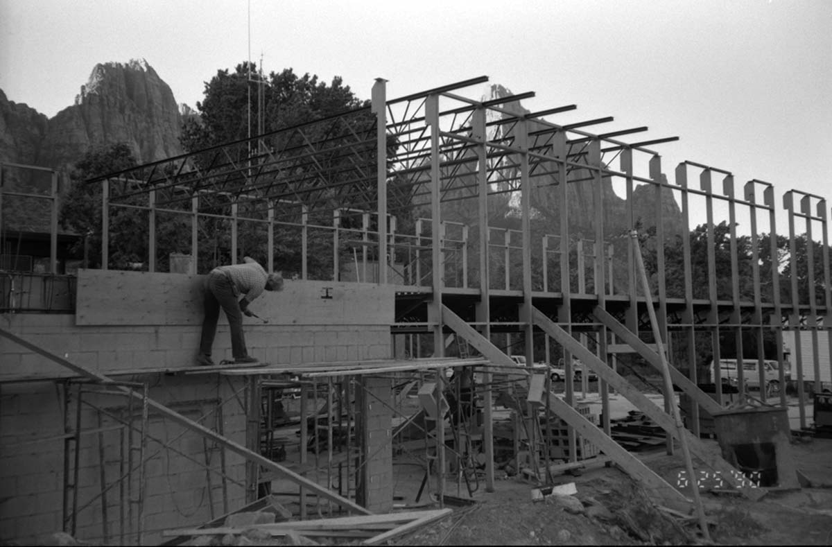 Man working on the construction of wall during the construction of the headquarters addition.
