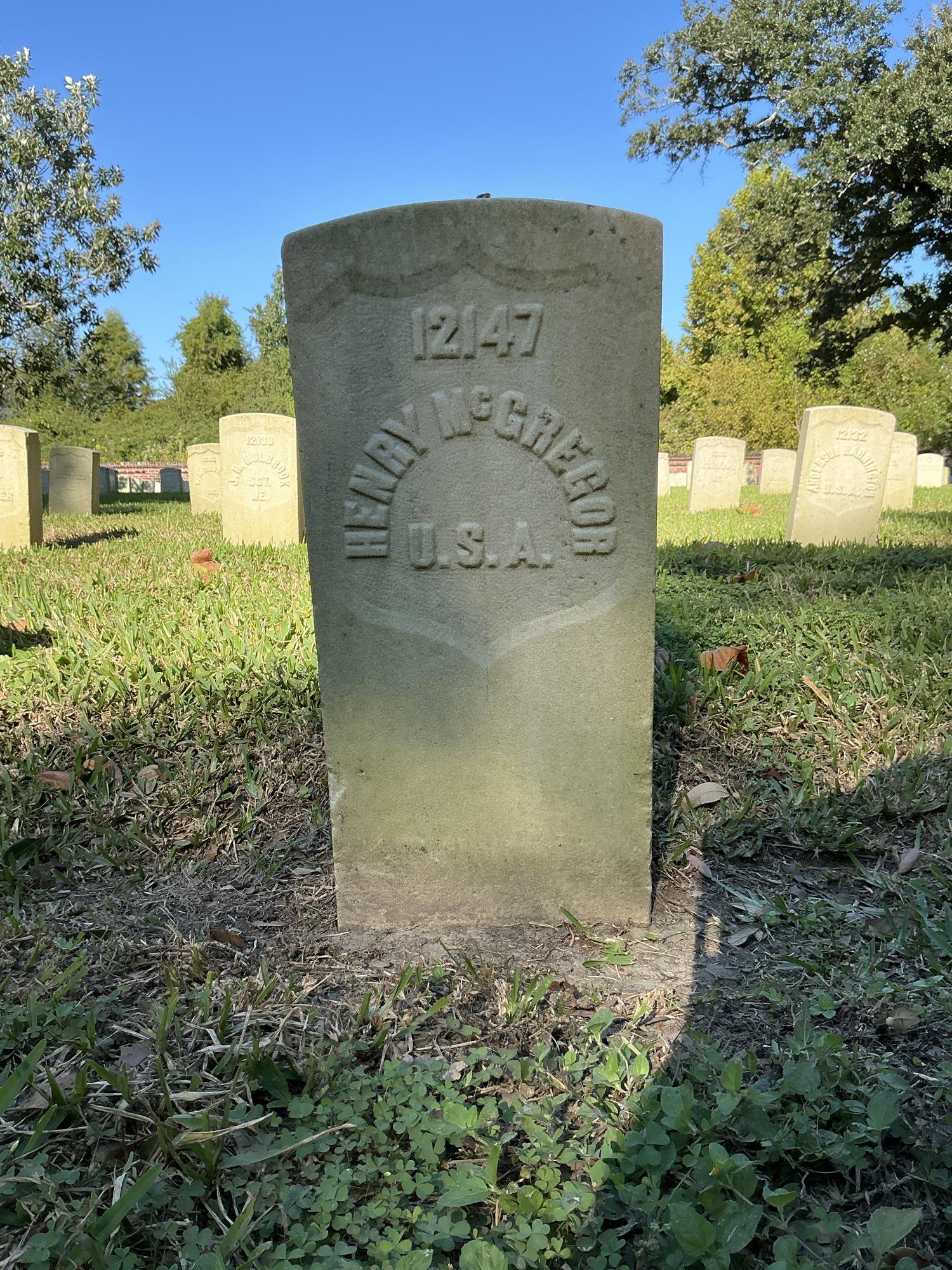 Front of historic upright marble headstone with recessed shield face.