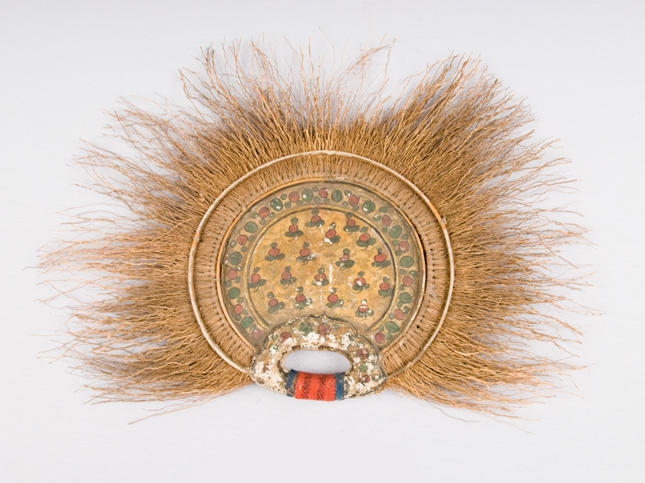 Semi-circular, consists of paper-covered wooden oval with applied flat edge to which is tied a flat array of dried brown grass that radiates in all directions except downward, where there is a semi-circular paper-covered open wooden handle. Paper on oval, handle painted with simple red flowers, leaves on gold ground.