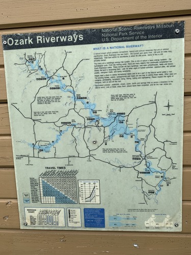 a faded park map on a bulletin board. the map is green and shows ozark national scenic riverways and places within. 