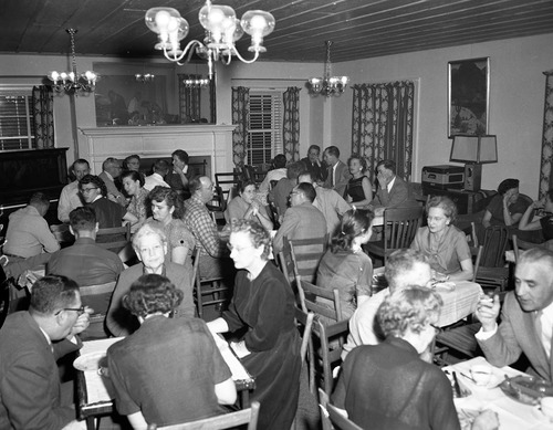 Men and women seated at tables in the ranger dormitory for Mr. and Mrs. Leland Allen's going away party. Allen accepted position in National Capitol Parks as GS-11 Naturalist.
