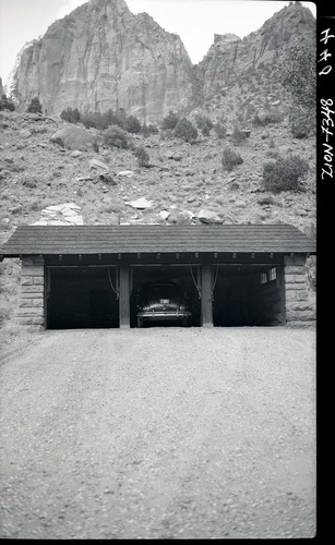 Three car garage, Building 110, with car inside.