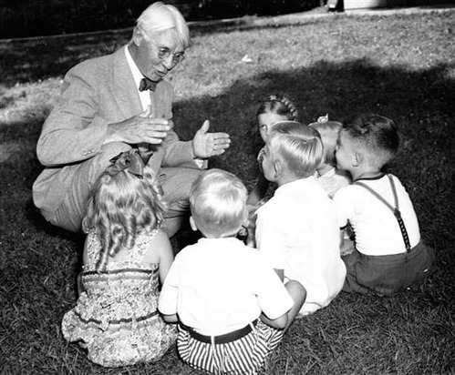 Man talking to a group of six children