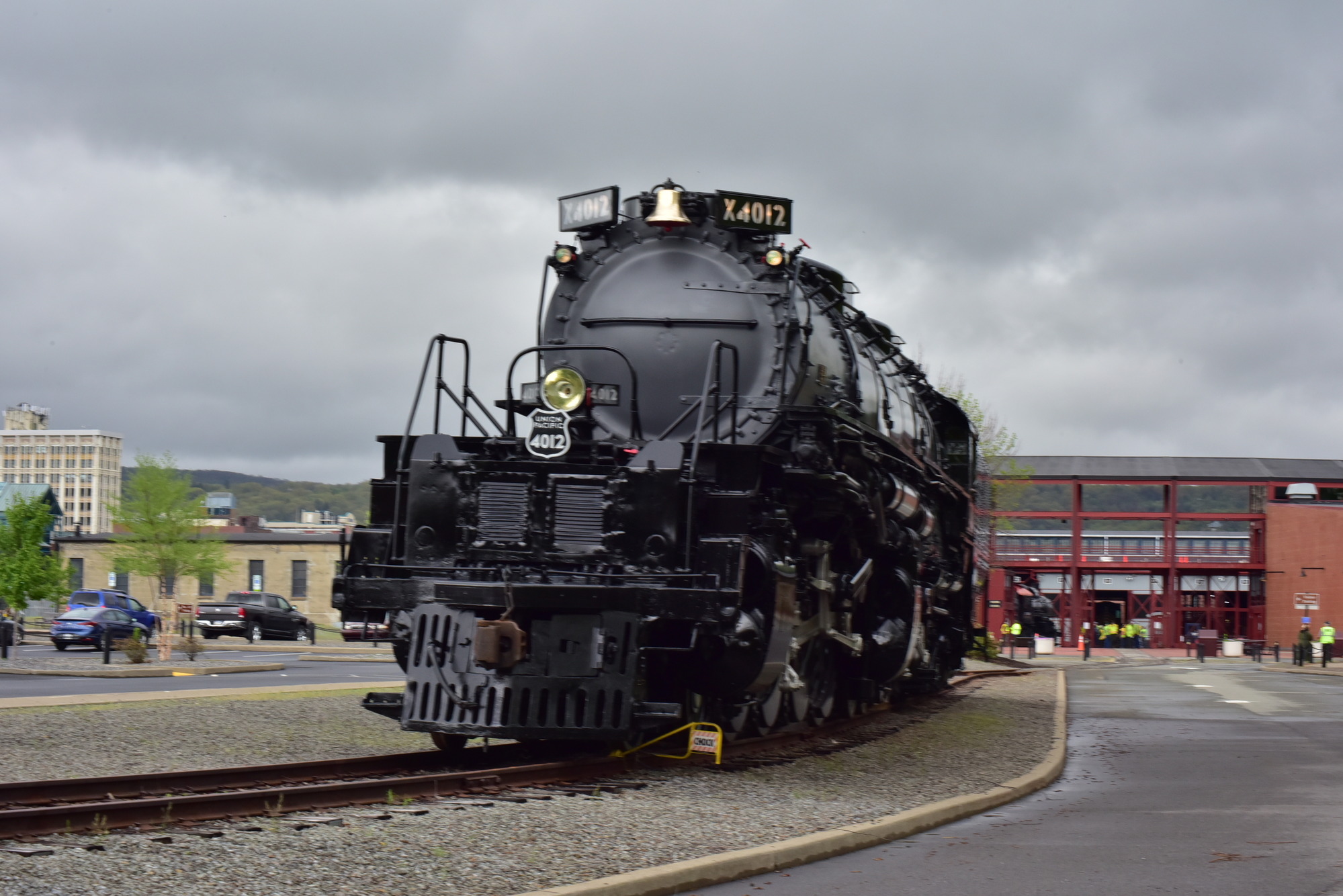 Large black train stationed on a curve in the track