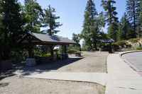 Paved paths lead to covered picnic tables near trees