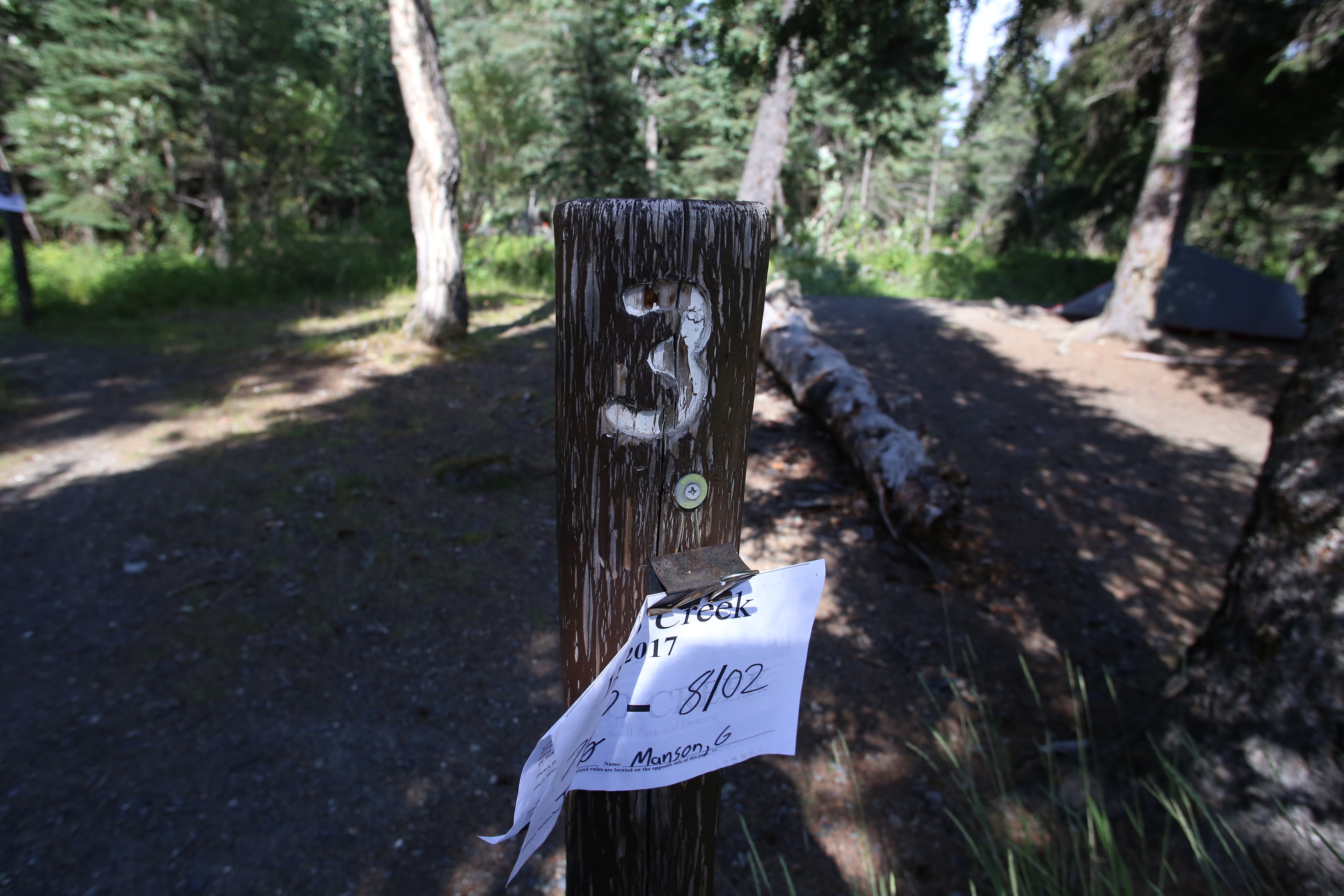 a wooden post with a note attached to it
