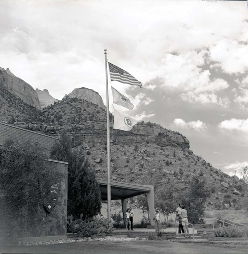 Mission 66 Visitor Center and Museum and bicentennial flags. [One of two images on single film strip for ZION 9061]